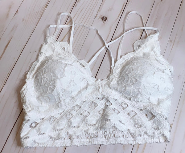 White Crochet Lace Bralette   Pull over style, long line, all day comfort V neckline  Removal bra pads  Criss-cross straps at back  Adjustable straps with perfect amount of stretch  Fabric: 90% nylon, 10% spandex  