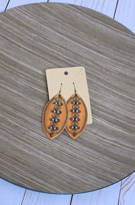 Light weight tan genuine leather carving detail earrings. *Lead Compliant 
