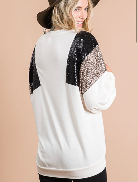 Cream top with shoulder black sequin color block with leopard detail. Fabric: 62% POLYESTER 33% RAYON 5% SPANDEX