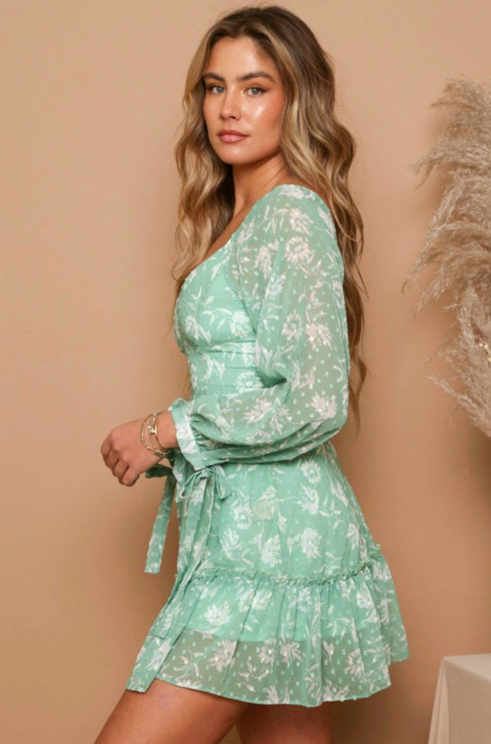 Mint/Ivory floral print swiss dress Long tie cuff sleeves  belted with tiered skirt and zipper closure on the back 